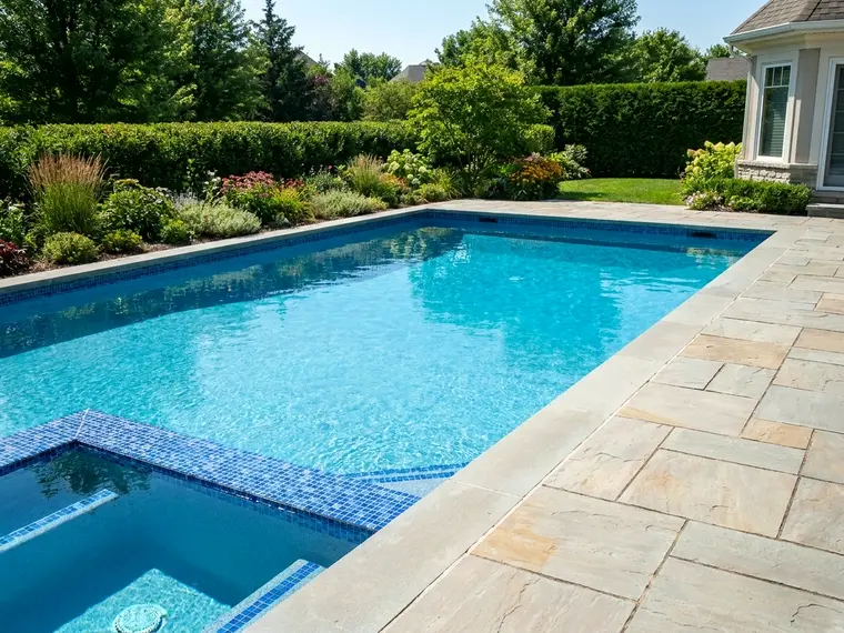 Clean backyard swimming pool with finished surround